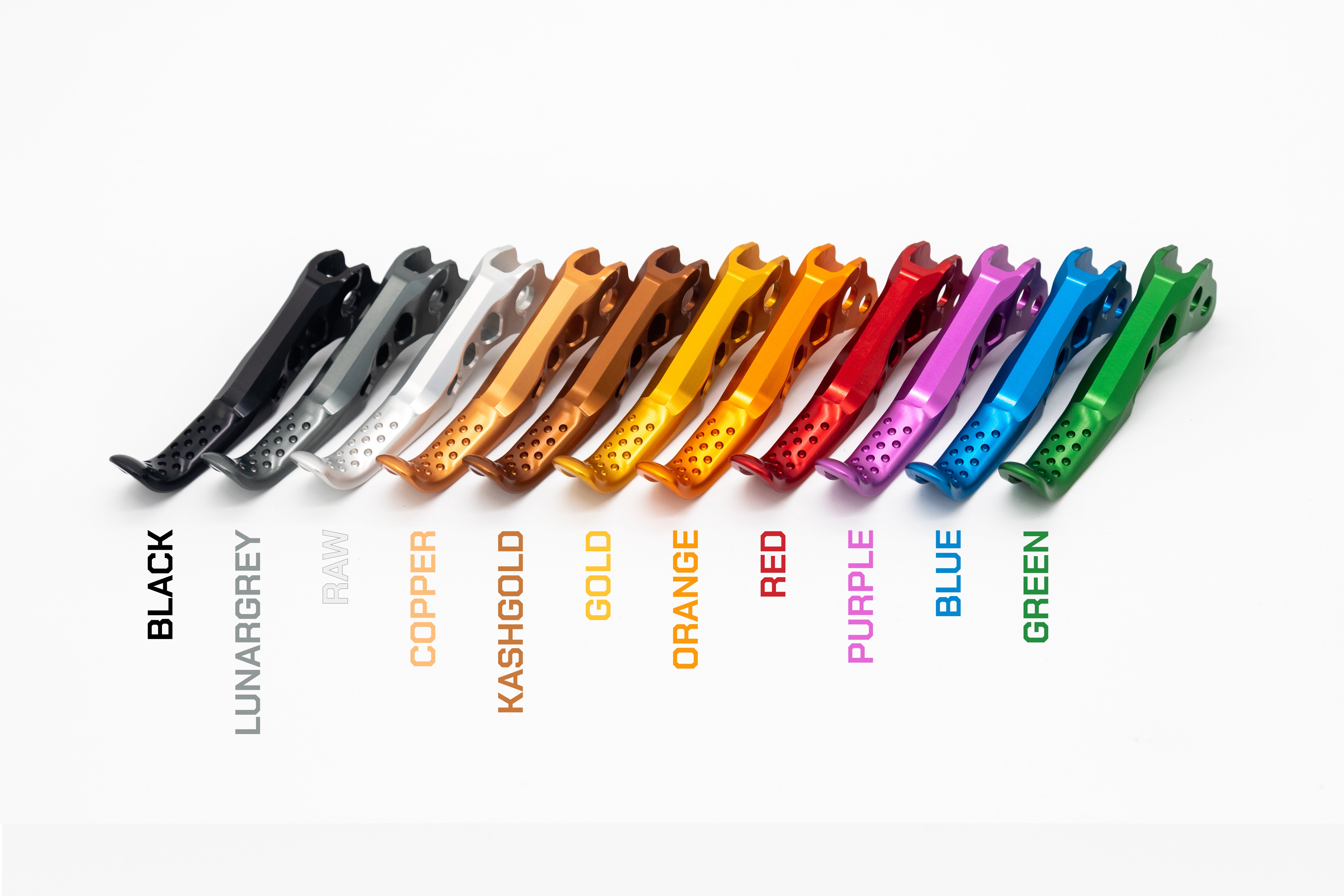 Eleven metallic, perforated mountain bike clips in various colors arranged diagonally on a white background