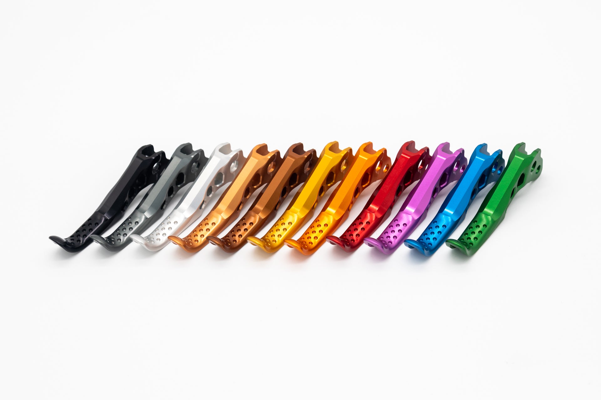 Twelve ergonomic mountain bike components in metallic colors ranging from black to green.