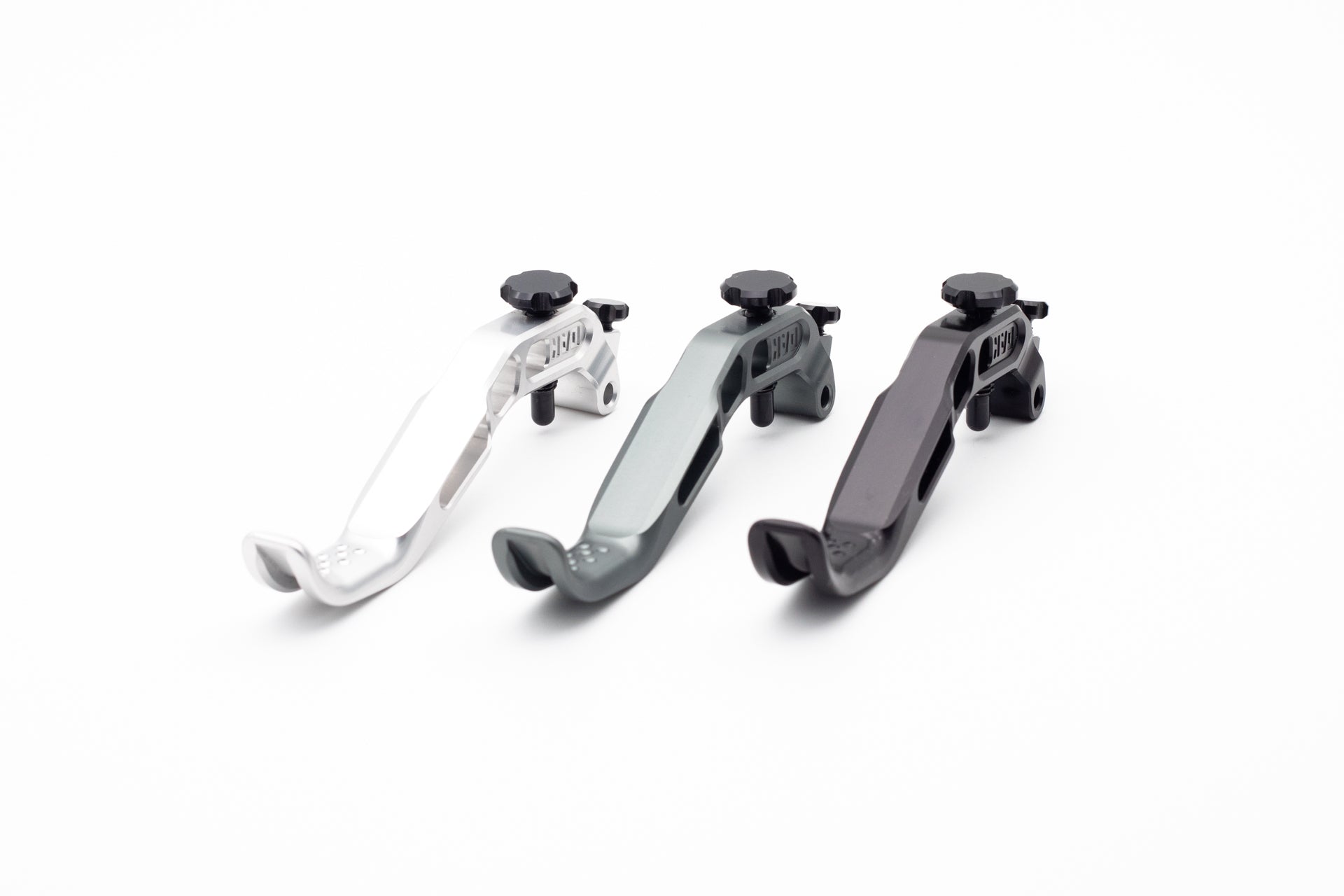Three metallic HERO levers in silver, grey, and black with adjustment knobs and screws for mountain biking.