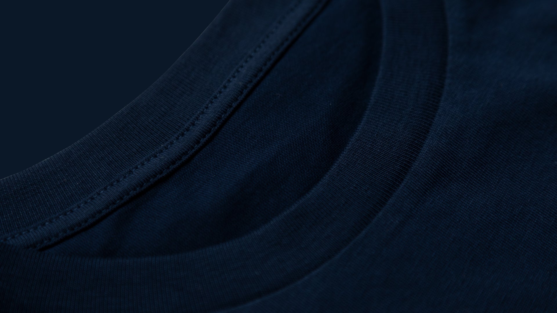 Close-up of dark blue high-quality fabric collar with detailed stitching for mountain biking apparel.
