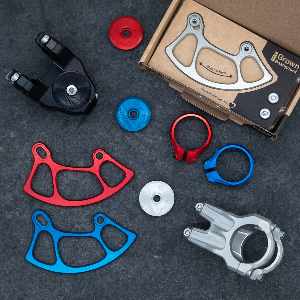 Overview picture of all OAK premium parts like the stem, bashguard and seatclamp