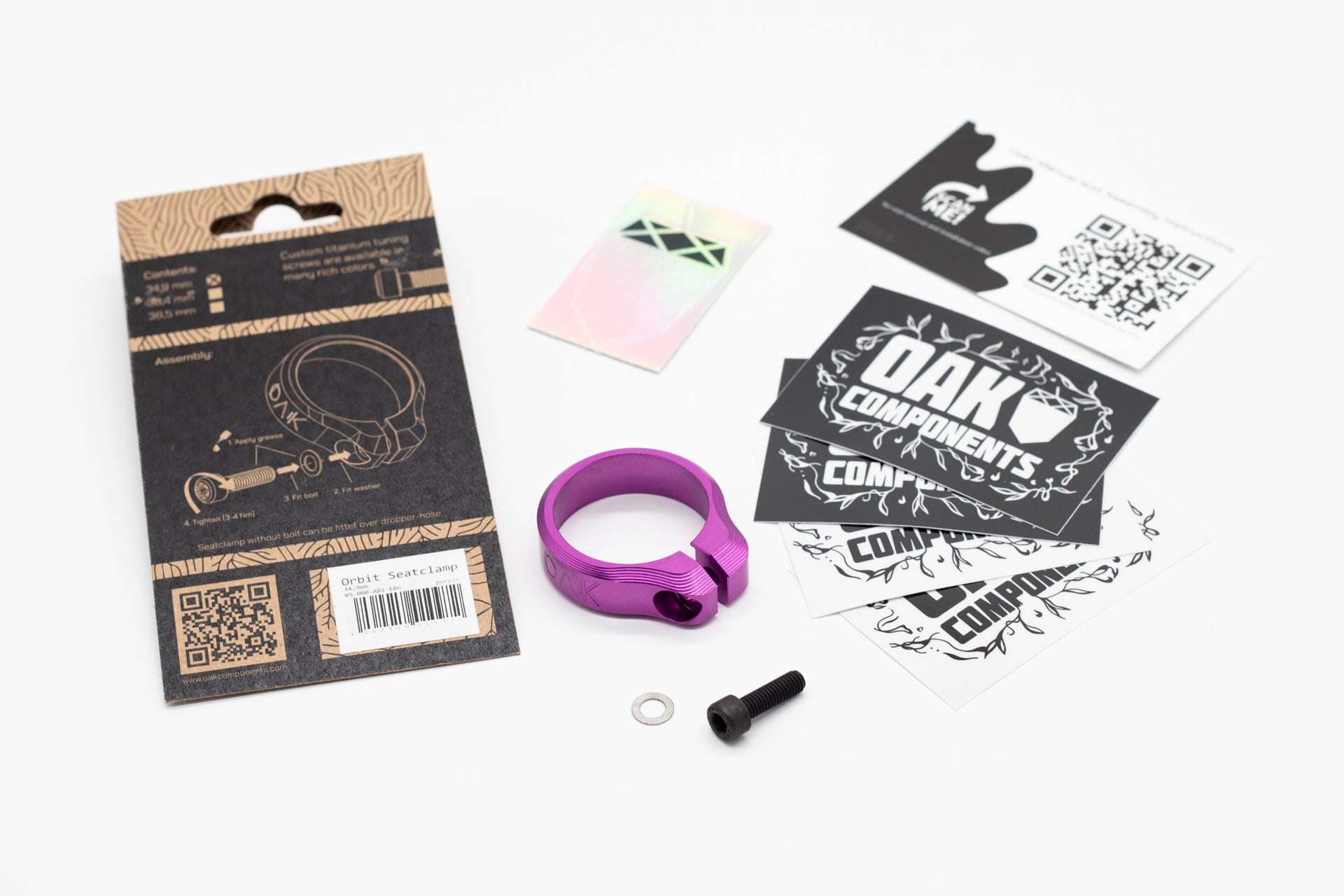 Purple OAK Orbit seat clamp with logo, black bolt, silver washer, and packaging with QR code