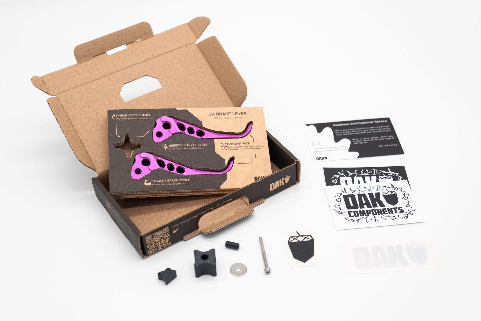 Set of two purple CNC-milled SR brake levers by OAK, on a display card with parts and OAK stickers.