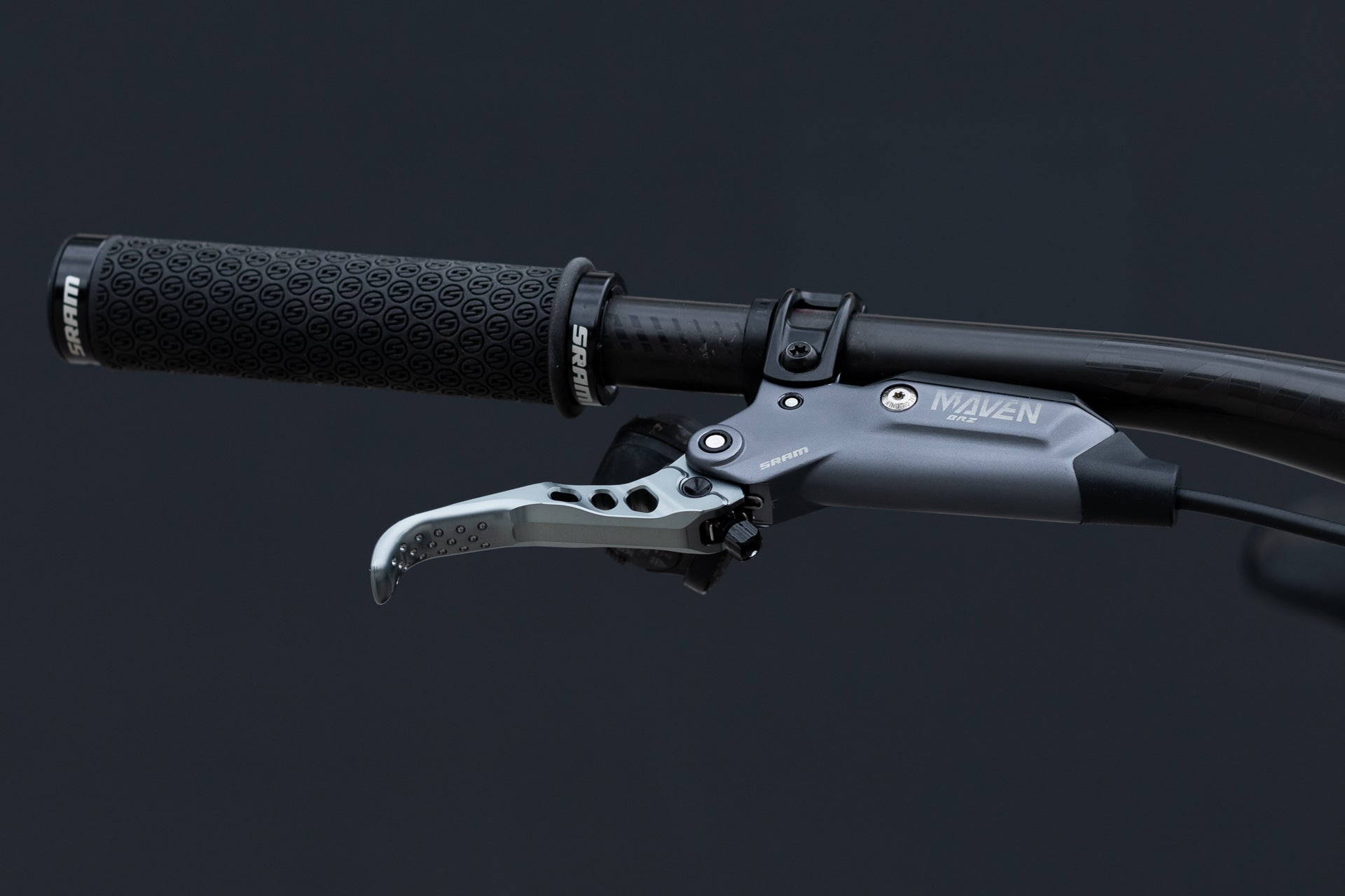 Close-up of a black textured SRAM mountain bike handlebar grip and SRAM MAVEN BRZ metallic brake lever.